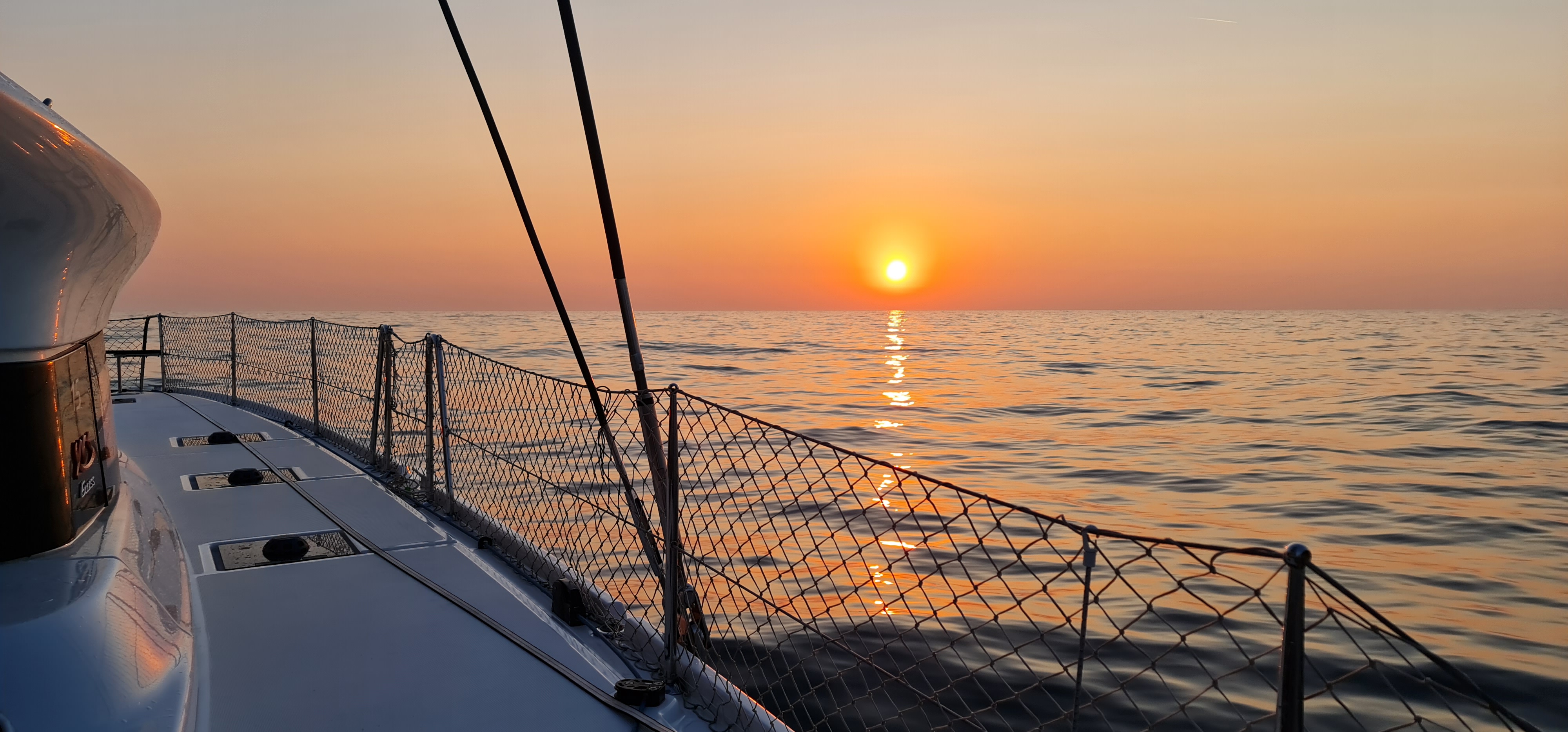 Open ocean passage under dramatic sunset sky